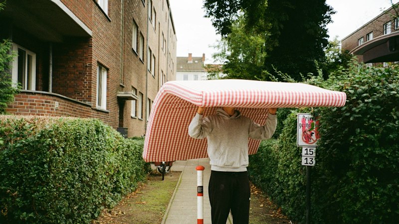 Mover carrying a mattress